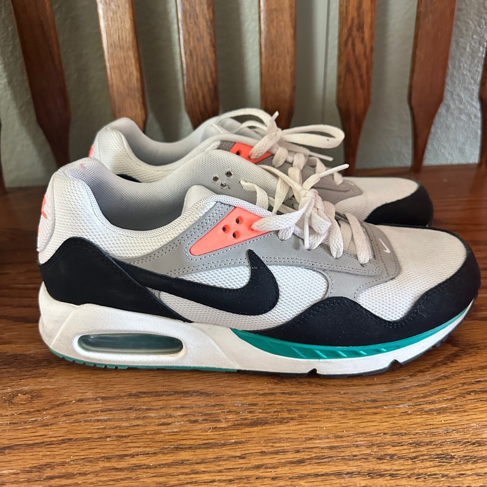 Nike women’s Athletic Shoes in White, Black, Gray with Teal and Coral Accents